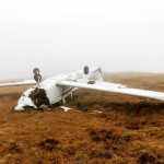DRUNK Co-Pilot Kills Six In Takeoff Horror Overturned crashed airplane on grassy field.