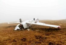 DRUNK Co-Pilot Kills Six In Takeoff Horror Overturned crashed airplane on grassy field.