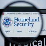 Major Immigration Sweep Hits New Orleans Magnifying glass showing Homeland Security website.