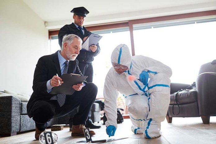 Forensic team examining evidence at a crime scene indoors.