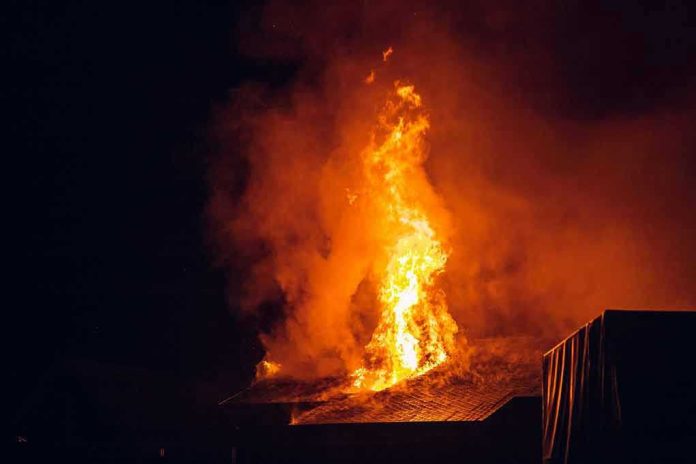 Building engulfed in large flames at night.