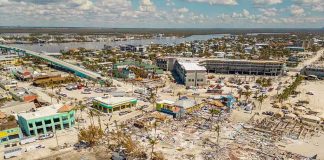 Aerial view of hurricane-damaged buildings and debris.