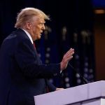 Texas Ranchers FURIOUS At Trump Person speaking at a podium with hand raised