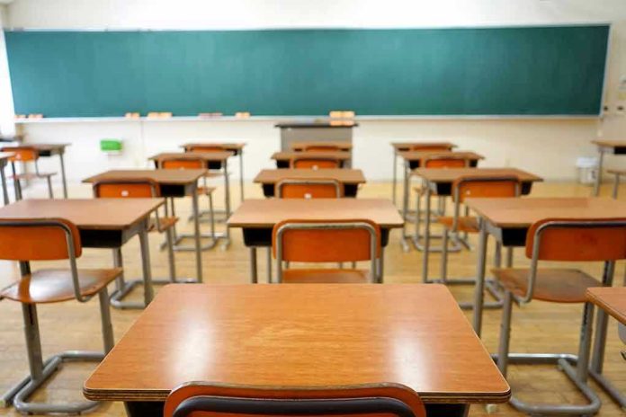 Empty classroom with desks and a chalkboard.
