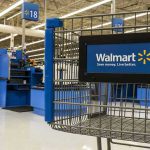 Black Friday DEATH: Corporate Greed Exposed Walmart shopping cart inside store near checkout aisle