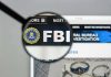 FBI IN TURMOIL: Patel’s Alleged Misuse Of Resources FBI website shown through magnifying glass.