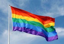 LGBTQ “Indoctrination” Allegations SHAKE Netflix A rainbow flag waving against a blue sky