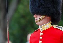 Ex-Soldier FOILS Parade Attack – Unbelievable! British soldier in ceremonial uniform with a black fur hat standing guard