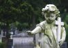 Teen Arrested in SHOCKING Child Murder Case Weathered statue of a child angel holding a cross in a cemetery