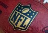 49ers Hit With Shocking Discrimination Allegations Close-up of an NFL football with the logo prominently displayed