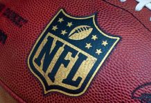 49ers Hit With Shocking Discrimination Allegations Close-up of an NFL football with the logo prominently displayed