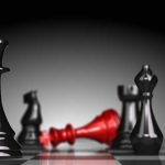 Chess World Divided In MASSIVE Cheating Showdown Black and red chess pieces on a board.