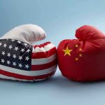 USA and China boxing gloves facing each other.