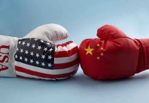 USA and China boxing gloves facing each other.