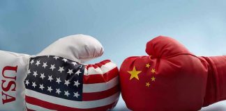 USA and China boxing gloves facing each other.