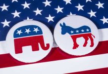 Manufactured Monster Now Wants Political Power Republican elephant and Democrat donkey on American flag.