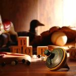 Outrage as Parents Stage Daughter’s Death A wooden spinning top surrounded by vintage toys and colorful blocks