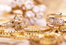 Close-up of various gold rings adorned with sparkling gems