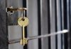 Key in lock of prison cell door.