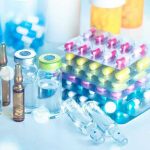 Scientists Discover How Psychedelics ERASE Reality Vials and blister packs of pills on table.