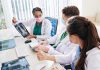 Doctors discussing chest X-ray results at a workstation.