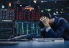 Trader stressed out by multiple declining stock charts.