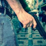 GATOR, Gun, Drugs—BUSTED On Bourbon Street Person holding a gun in a crowded street.