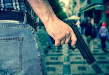 GATOR, Gun, Drugs—BUSTED On Bourbon Street Person holding a gun in a crowded street.