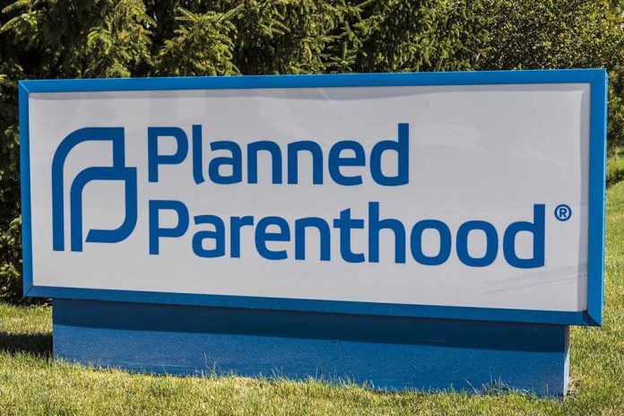 670284427 Planned Parenthood sign on a grassy lawn.