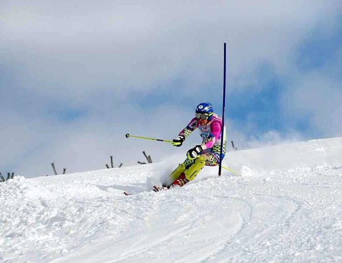 Athlete skiing down a snowy slope around a slalom pole