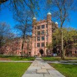 Pro-Abortion Advocacy Meets Elite Campus Power Historic university building surrounded by green grass and trees under a blue sky