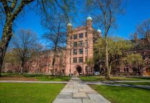 Pro-Abortion Advocacy Meets Elite Campus Power Historic university building surrounded by green grass and trees under a blue sky