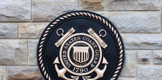 Bronze emblem of the United States Coast Guard mounted on a stone wall