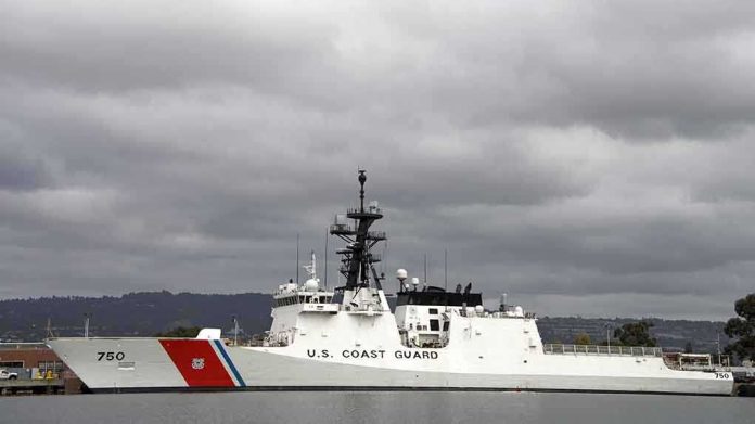 A U.S. Coast Guard ship docked under cloudy skies