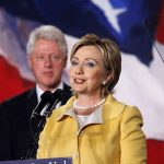 Clintons CAVE–Epstein Probe Tightens! Hillary Clinton delivering a speech with Bill Clinton in the background