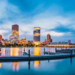 City skyline with waterfront at twilight.