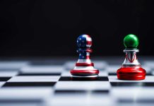 Iran War Erupts—Soldier Picks OTHER Side Chess pieces with USA and Iran flags on board.