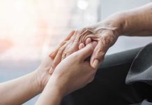 Elderly Targeted: $17.4M Scam Exposed Young hands holding an elderly persons hand.