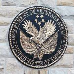 Department of Veterans Affairs seal on brick wall.