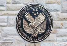 Department of Veterans Affairs seal on brick wall.