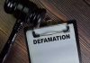 Gavel and clipboard with Defamation text.