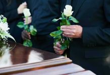Senior Prank KILLS Beloved Teacher Mourners holding white roses by a casket.
