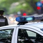 No Warrant, No Arrest—Police Access Everything Now Police car and officer on a city street.