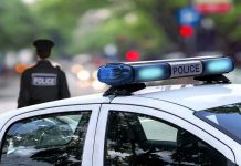 No Warrant, No ArrestâPolice Access Everything Now Police car and officer on a city street.