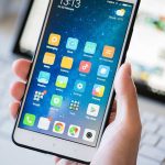 Phone Crackdown Stuns UAE During War A person holding a smartphone displaying various mobile applications