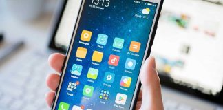 Phone Crackdown Stuns UAE During War A person holding a smartphone displaying various mobile applications