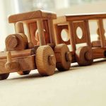 Daycare Begged Authorities — Child DEAD Weeks Later A wooden toy train set on a carpeted surface