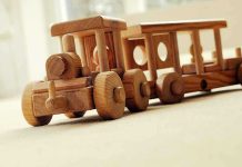 Daycare Begged Authorities — Child DEAD Weeks Later A wooden toy train set on a carpeted surface