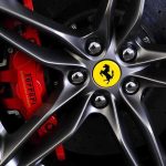Close-up of a Ferrari wheel showcasing the brake caliper and logo