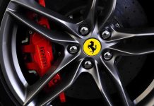 Supercar Scheme EXPLODES Into Criminal Charges Close-up of a Ferrari wheel showcasing the brake caliper and logo